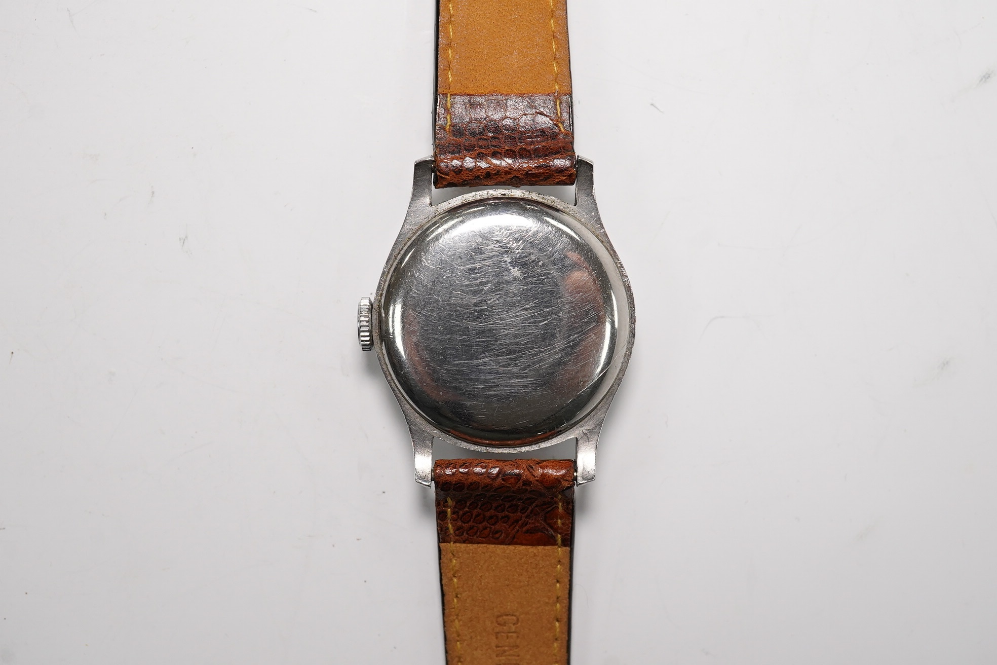 A gentleman's steel Longines manual wind wrist watch, with Arabic and baton numerals, and subsidiary seconds, movement c.11L, case diameter 30mm, on a later associated leather strap. Condition - poor